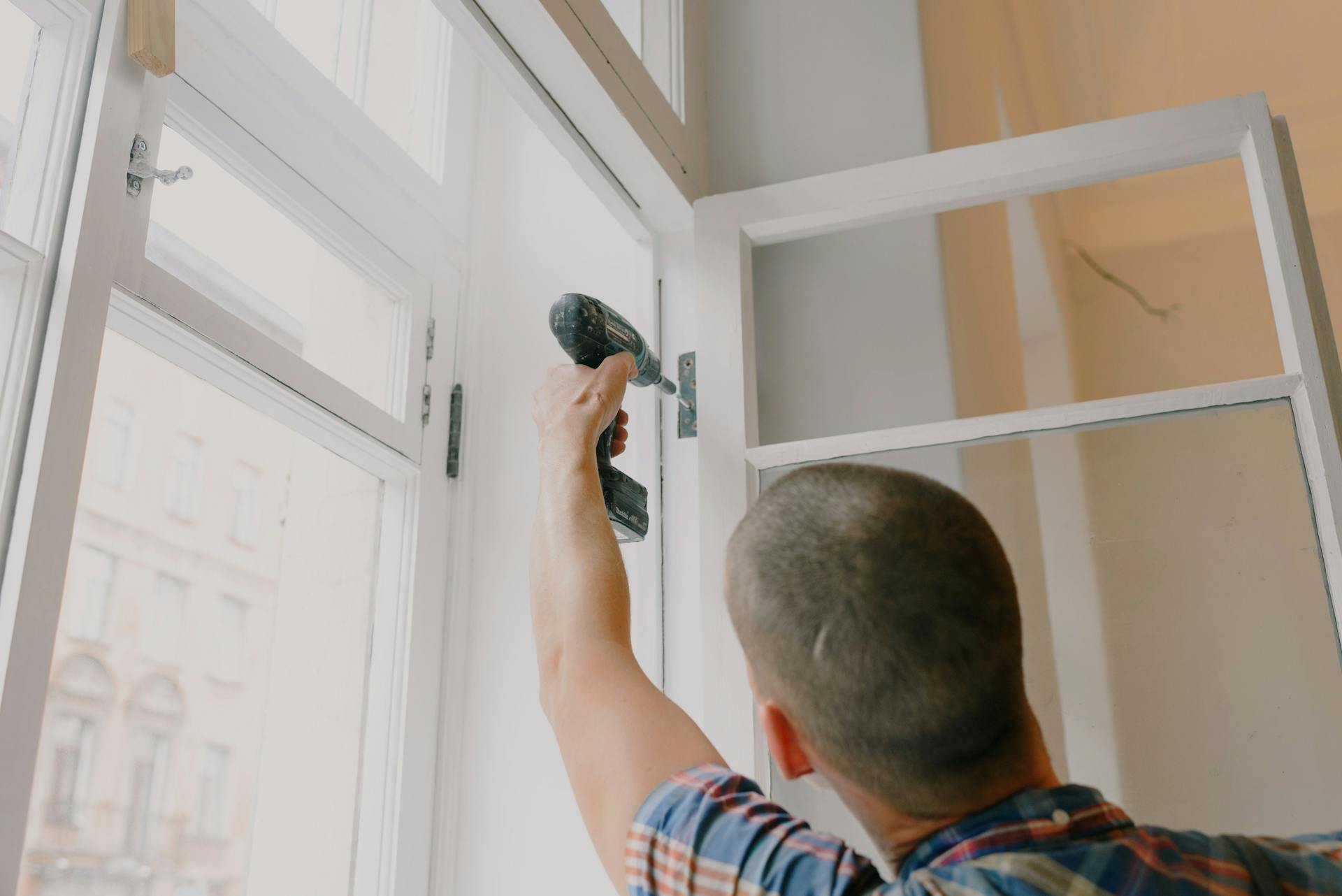 Technician fitting a door